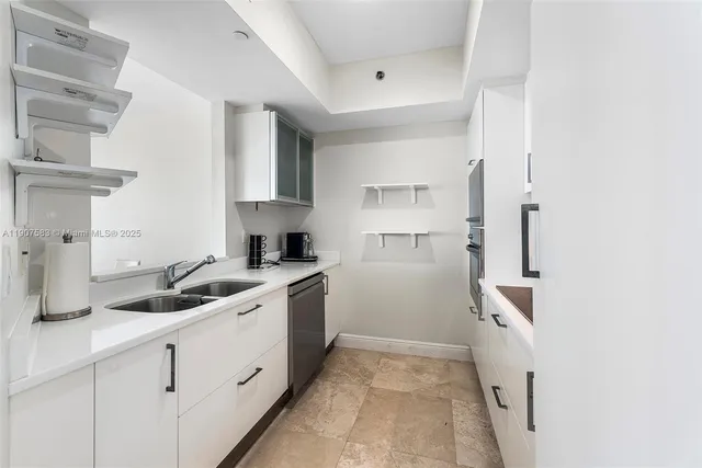 a kitchen with a sink and cabinets
