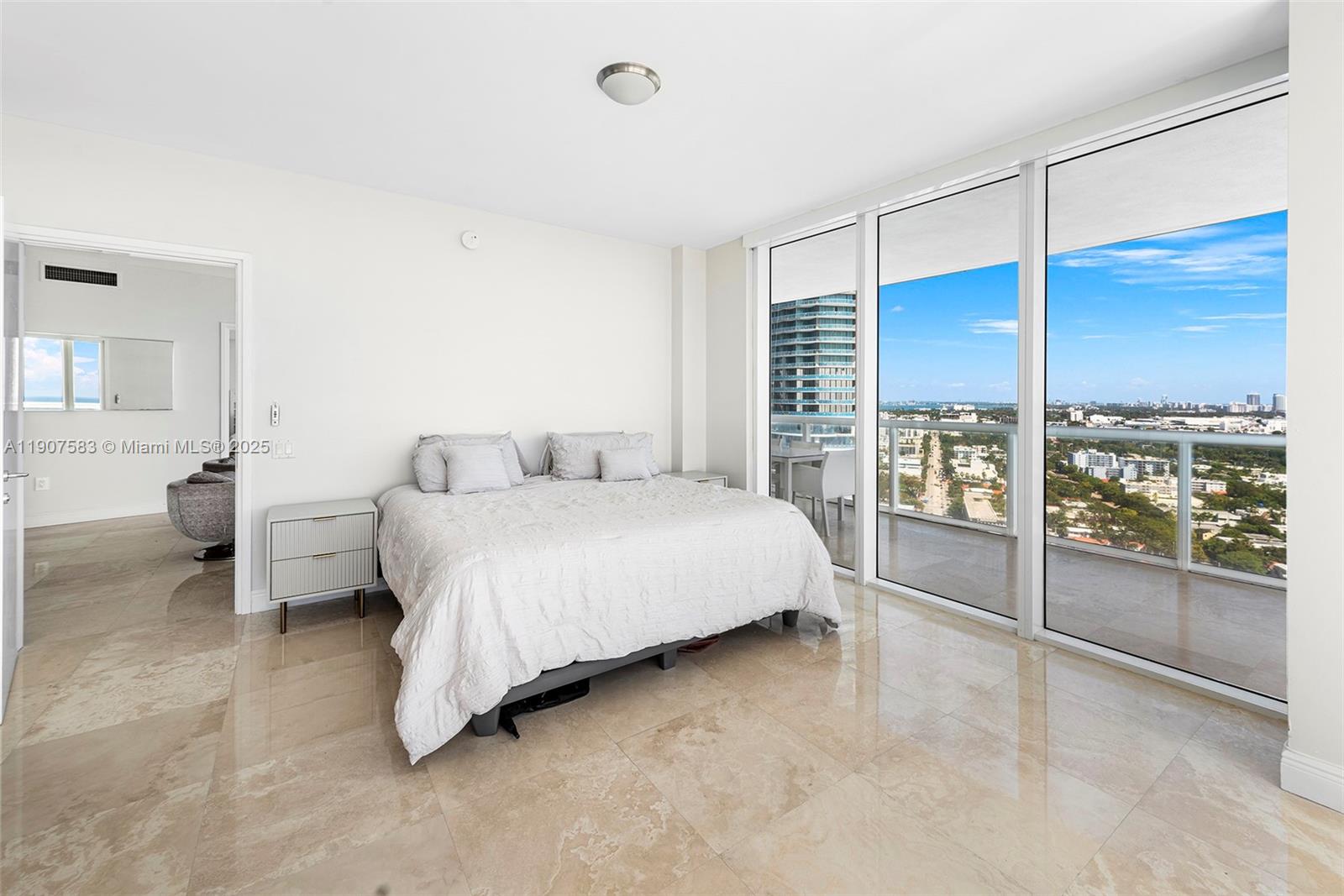 450 Alton Road, Unit 3010 Miami Beach, FL 33139 - Photo 15 of 62 a spacious bedroom with a bed and large window