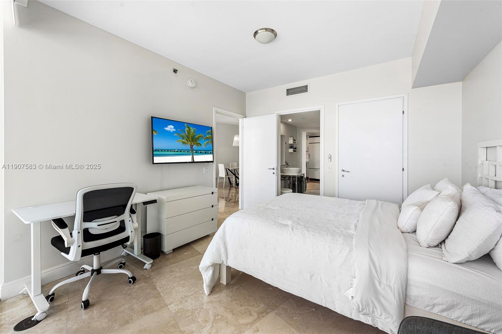 450 Alton Road, Unit 3010 Miami Beach, FL 33139 - Photo 32 of 62 a bedroom with a bed and a chair