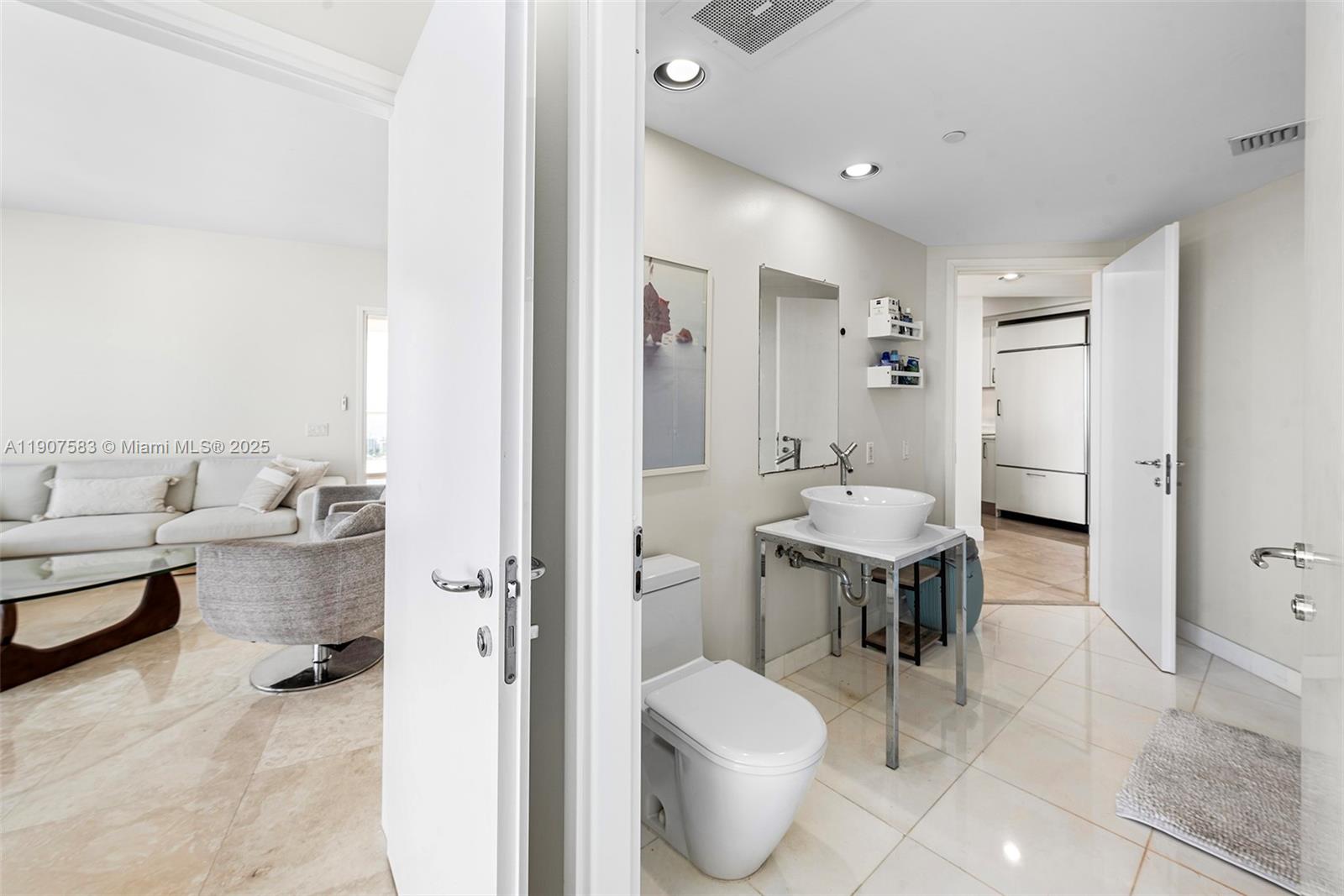 450 Alton Road, Unit 3010 Miami Beach, FL 33139 - Photo 34 of 62 a spacious bathroom with a toilet sink and a mirror