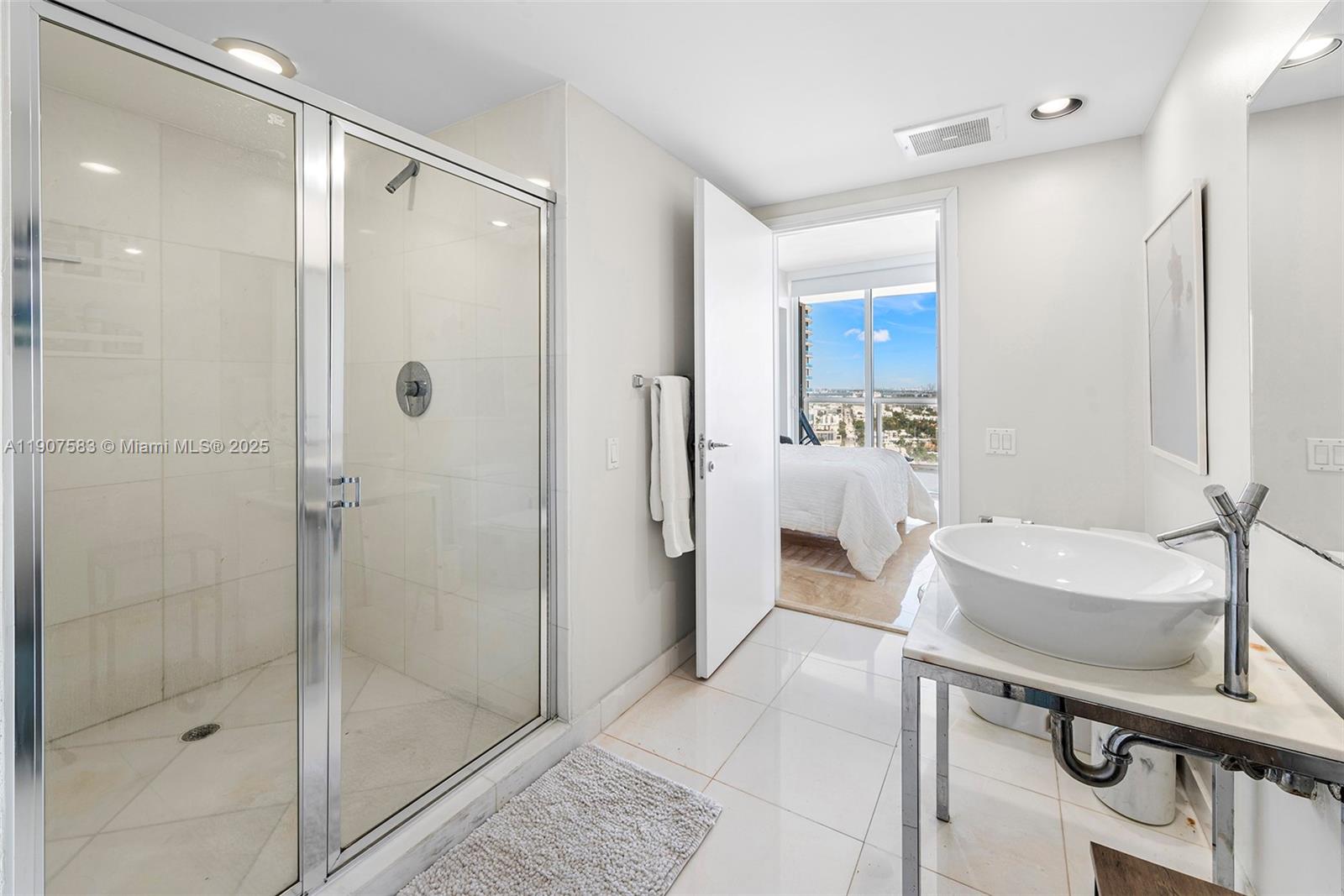 450 Alton Road, Unit 3010 Miami Beach, FL 33139 - Photo 36 of 62 a bathroom with a sink mirror toilet shower and bathtub