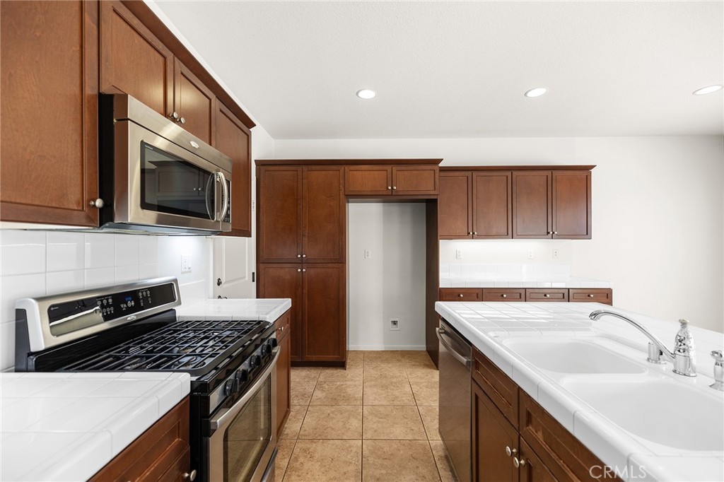 12047 Dewar Drive Riverside, CA 92505 - Photo 11 of 40 a kitchen with a sink stove and microwave