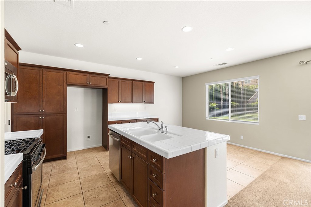 12047 Dewar Drive Riverside, CA 92505 - Photo 12 of 40 a kitchen with a sink cabinets and appliances