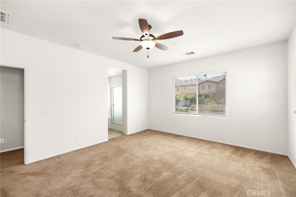 12047 Dewar Drive Riverside, CA 92505 - Photo 20 of 40 an empty room with window and ceiling fan