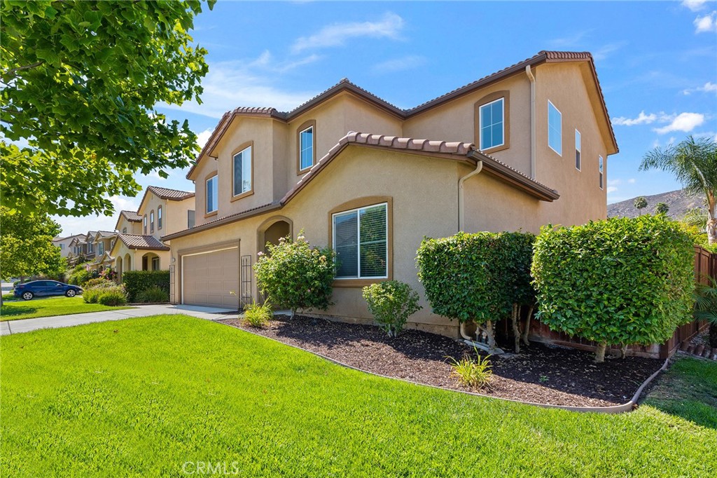 12047 Dewar Drive Riverside, CA 92505 - Photo 4 of 40 a front view of a house with a garden and plants