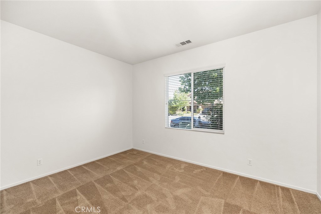 12047 Dewar Drive Riverside, CA 92505 - Photo 7 of 40 an empty room with a window