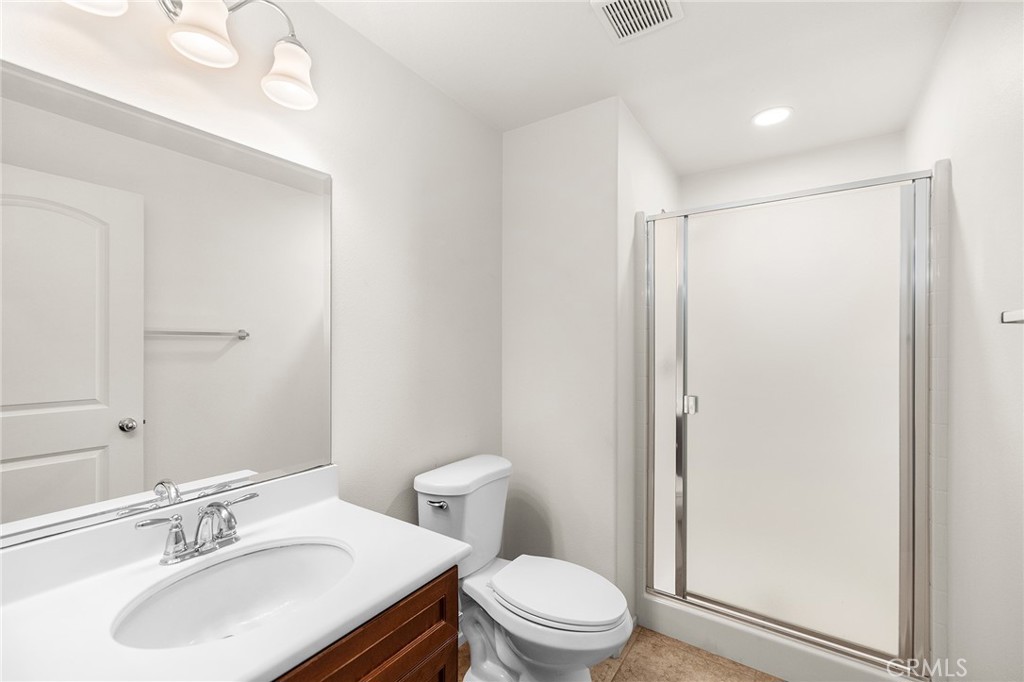 12047 Dewar Drive Riverside, CA 92505 - Photo 8 of 40 a bathroom with a sink toilet vanity and shower