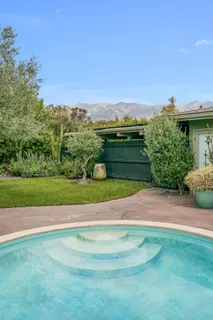 an aerial view of a house with a yard basket ball court and outdoor seating