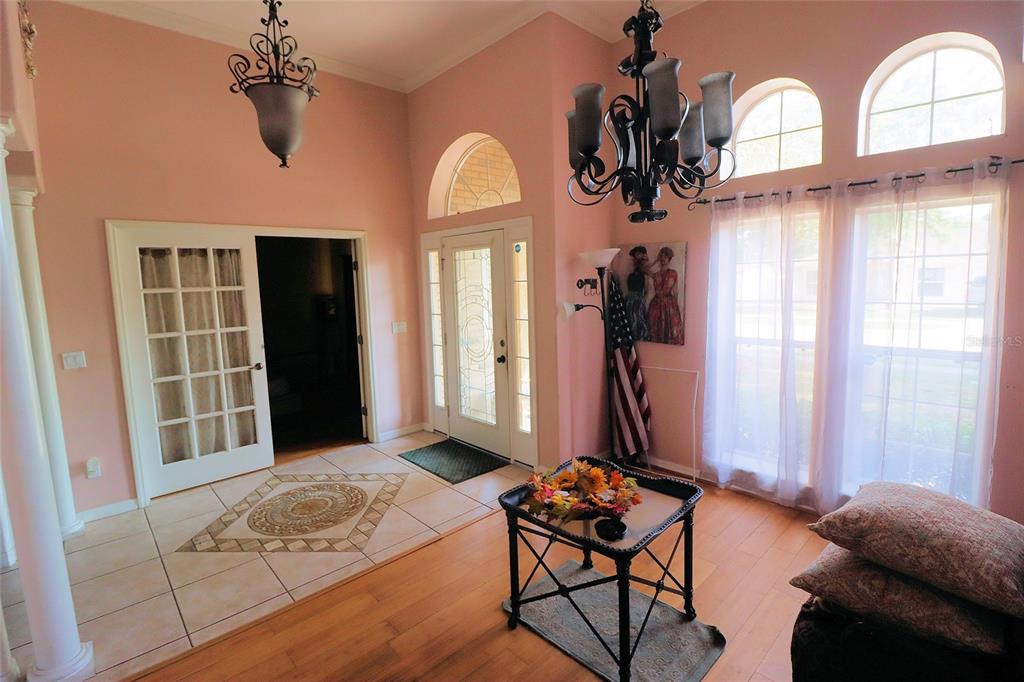 396 Kettering Road Deltona, FL 32725 - Photo 4 of 25 a living room with furniture a dining table with wooden floor