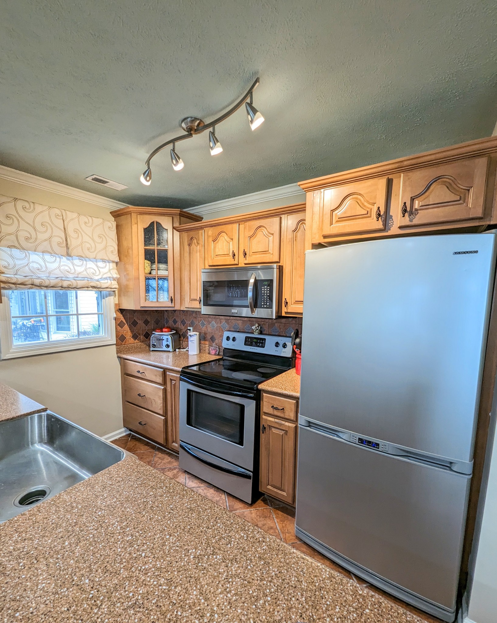 226 Pleasant Place, Unit B2 Springville, TN 38256 - Photo 19 of 43 a kitchen with stainless steel appliances granite countertop a refrigerator a sink dishwasher a stove and white countertops with wooden floor