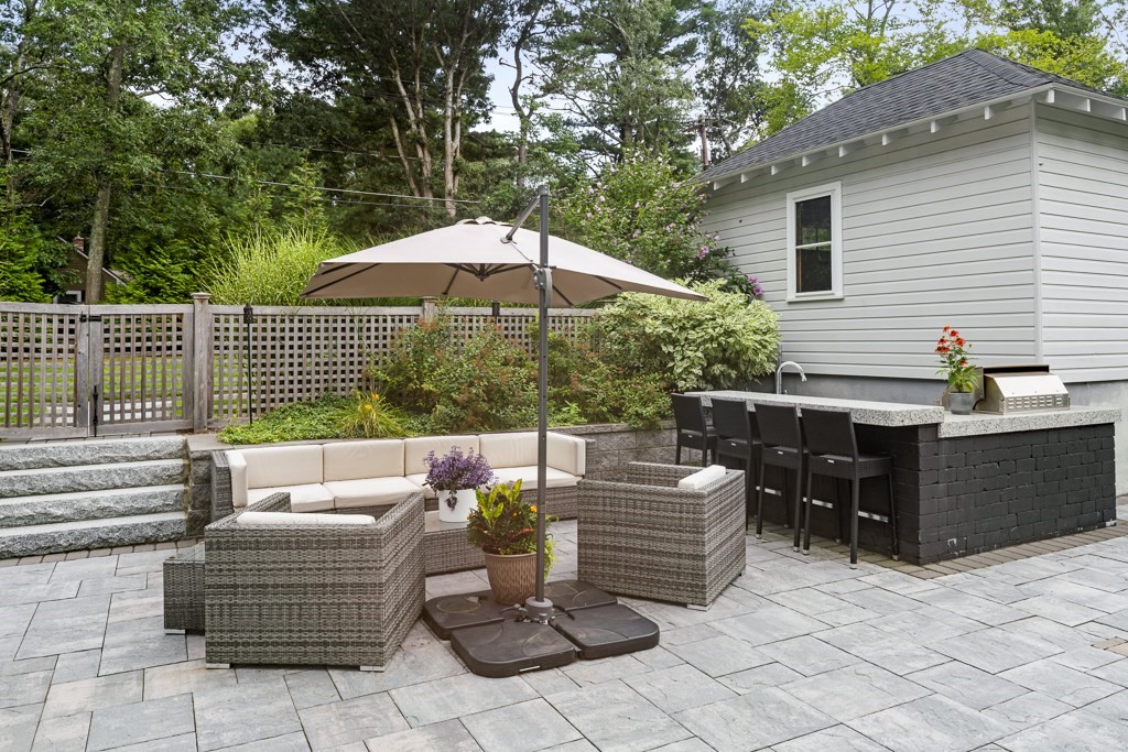 60 Rice Road Wayland, MA 01778 - Photo 20 of 26 a view of backyard with seating space and wooden fence