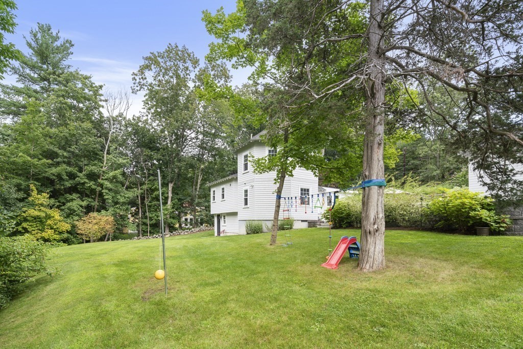 60 Rice Road Wayland, MA 01778 - Photo 23 of 26 a view of a house with a backyard and a tree