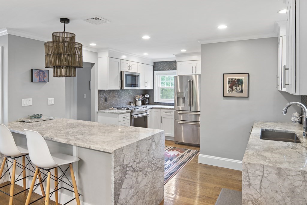 60 Rice Road Wayland, MA 01778 - Photo 3 of 26 a kitchen with stainless steel appliances granite countertop a sink refrigerator and microwave