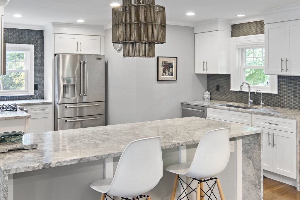 60 Rice Road Wayland, MA 01778 - Photo 4 of 26 a kitchen with stainless steel appliances granite countertop a sink refrigerator and microwave