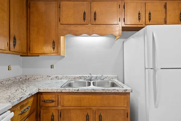 a kitchen that has a sink and a stove in it