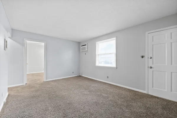 a view of an empty room with a window