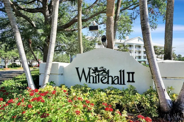 a sign that is sitting in front of flowers