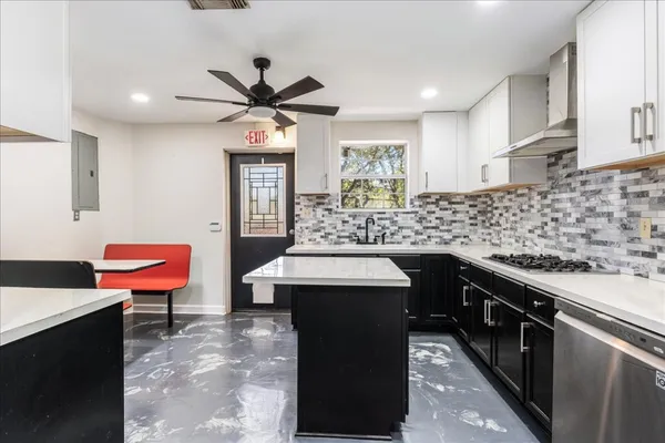 a kitchen with a sink stove and refrigerator