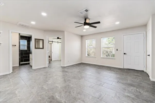 a kitchen with a refrigerator a stove top oven and white cabinets