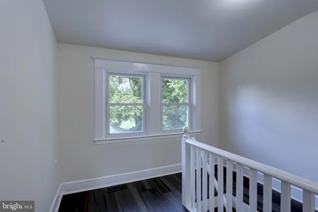 a bathroom with a light fixture a mirror and a sink