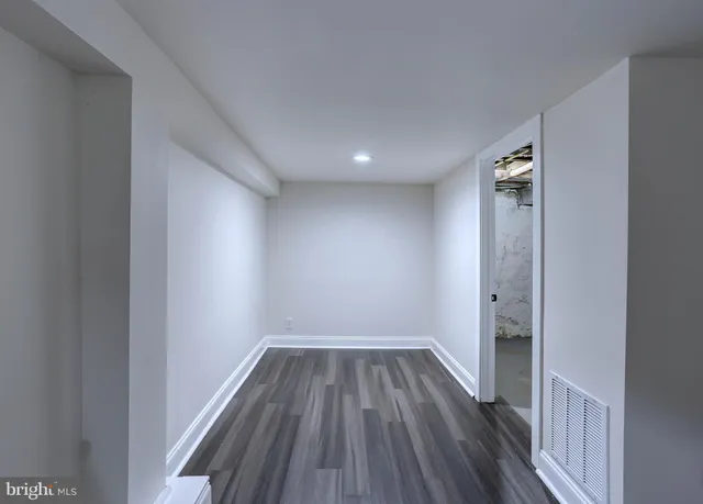 a view of hallway with wooden floor
