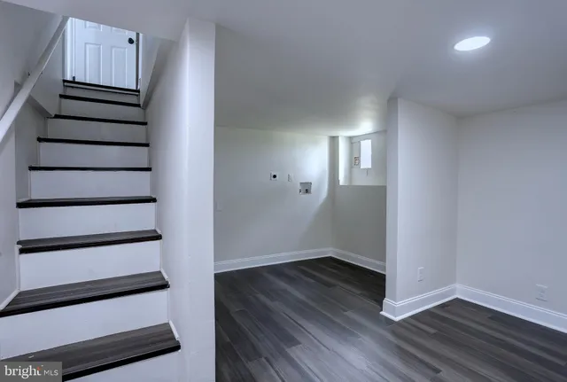 a view of a house with a yard and a wooden deck
