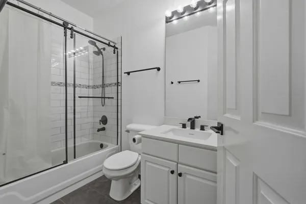 a bathroom with a sink toilet and shower