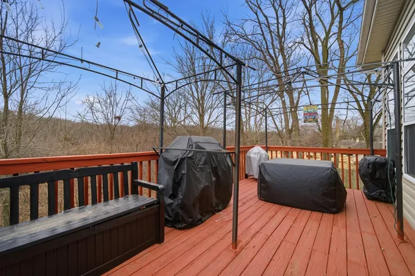 a view of balcony with wooden floor and outdoor seating