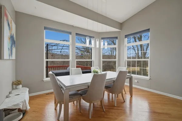 a view of a dining room with furniture window and wooden floor
