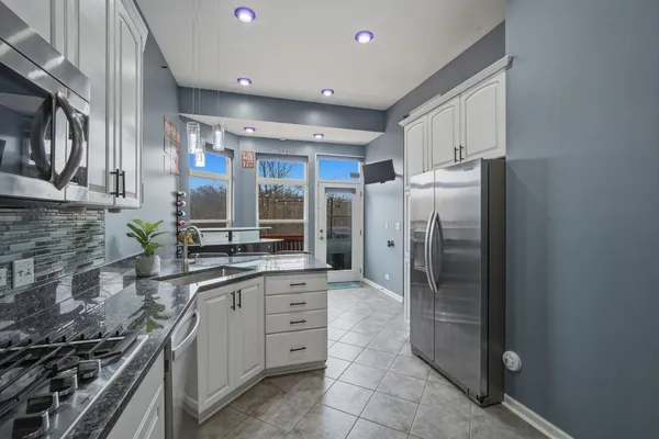 a kitchen with stainless steel appliances a refrigerator and a sink