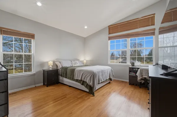a spacious bedroom with a bed and a large window