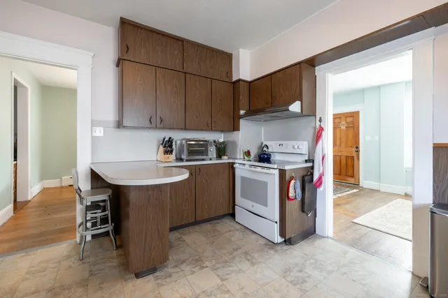 a kitchen with stainless steel appliances granite countertop a sink a stove and a refrigerator