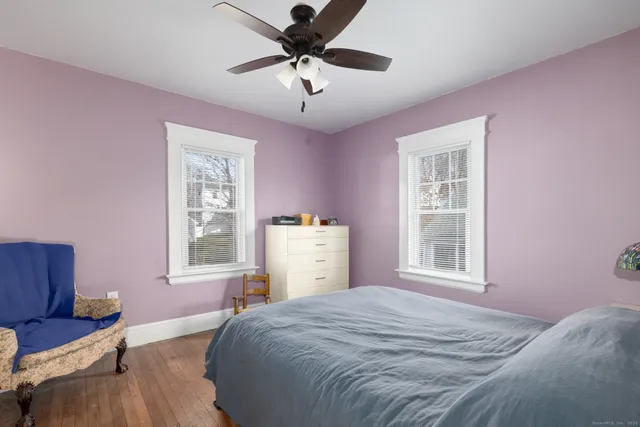 a bedroom with a bed dresser and a window