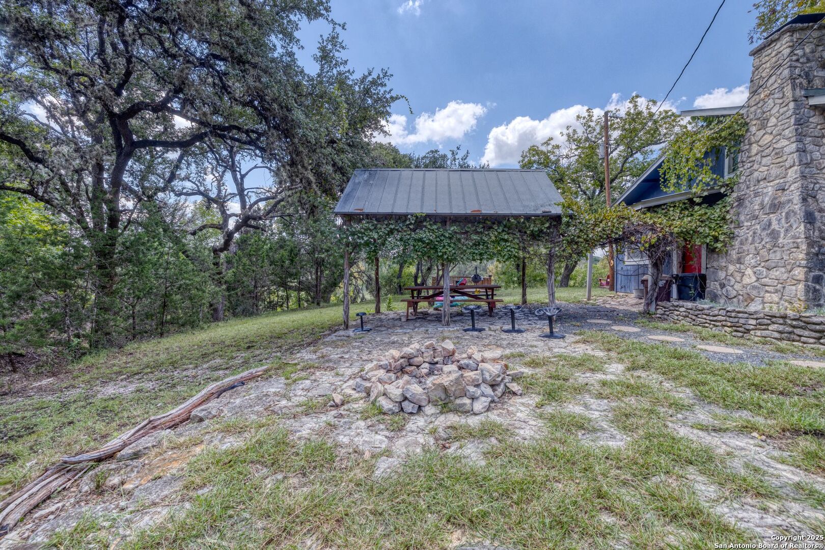 394 Squirrel Bend Uvalde, TX 78801 - Photo 11 of 80 a view of a backyard with a table and chairs under an umbrella