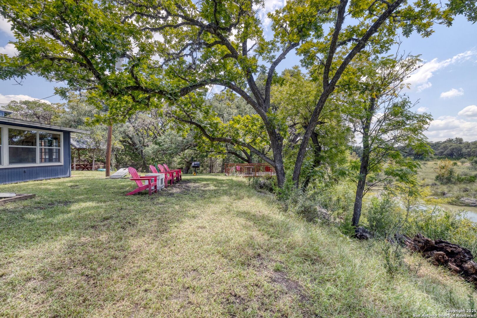 394 Squirrel Bend Uvalde, TX 78801 - Photo 4 of 80 a backyard of a house with table and chairs