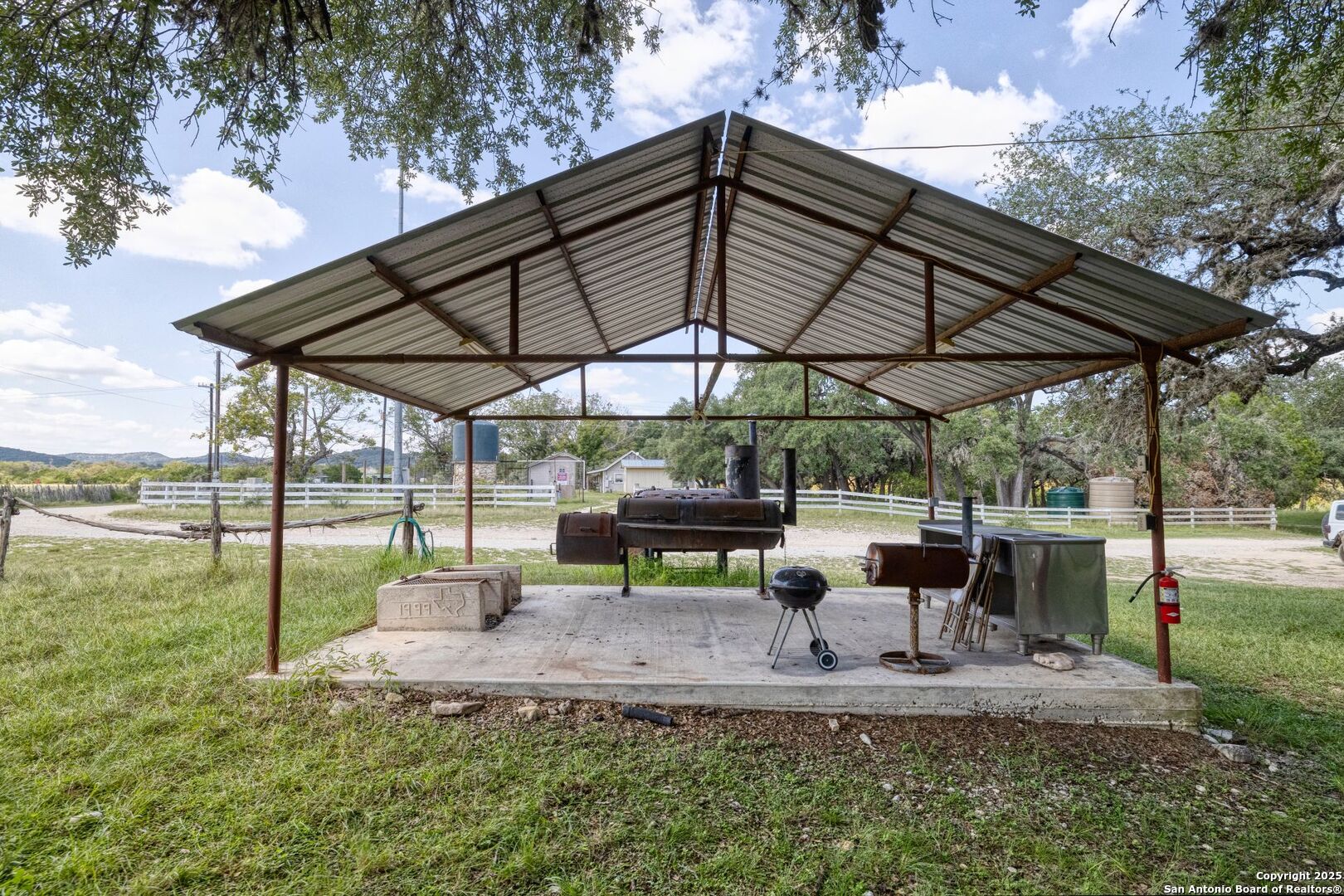 394 Squirrel Bend Uvalde, TX 78801 - Photo 43 of 80 a view of backyard with table and chairs under an umbrella