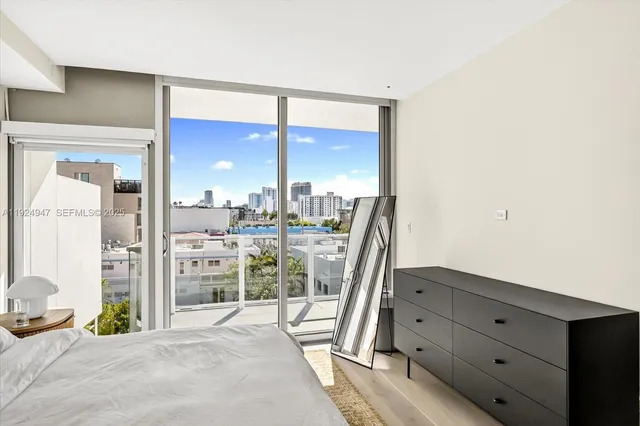 a bedroom with a bed and large window