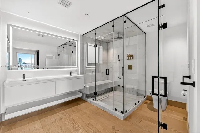 a spacious bathroom with a tub shower and mirror