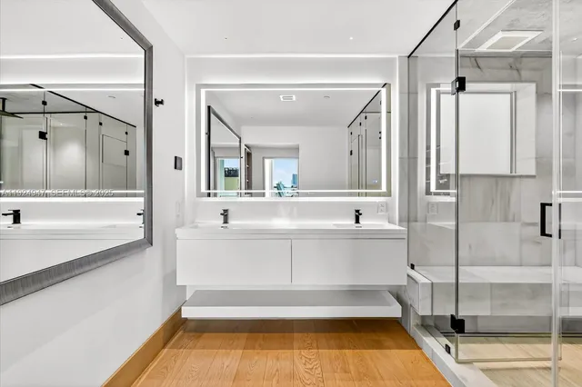 a bathroom with a tub sink and mirror