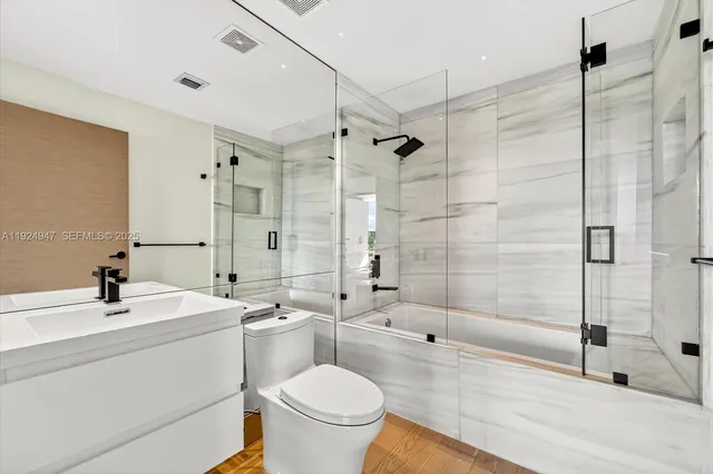 a bathroom with a sink toilet and shower