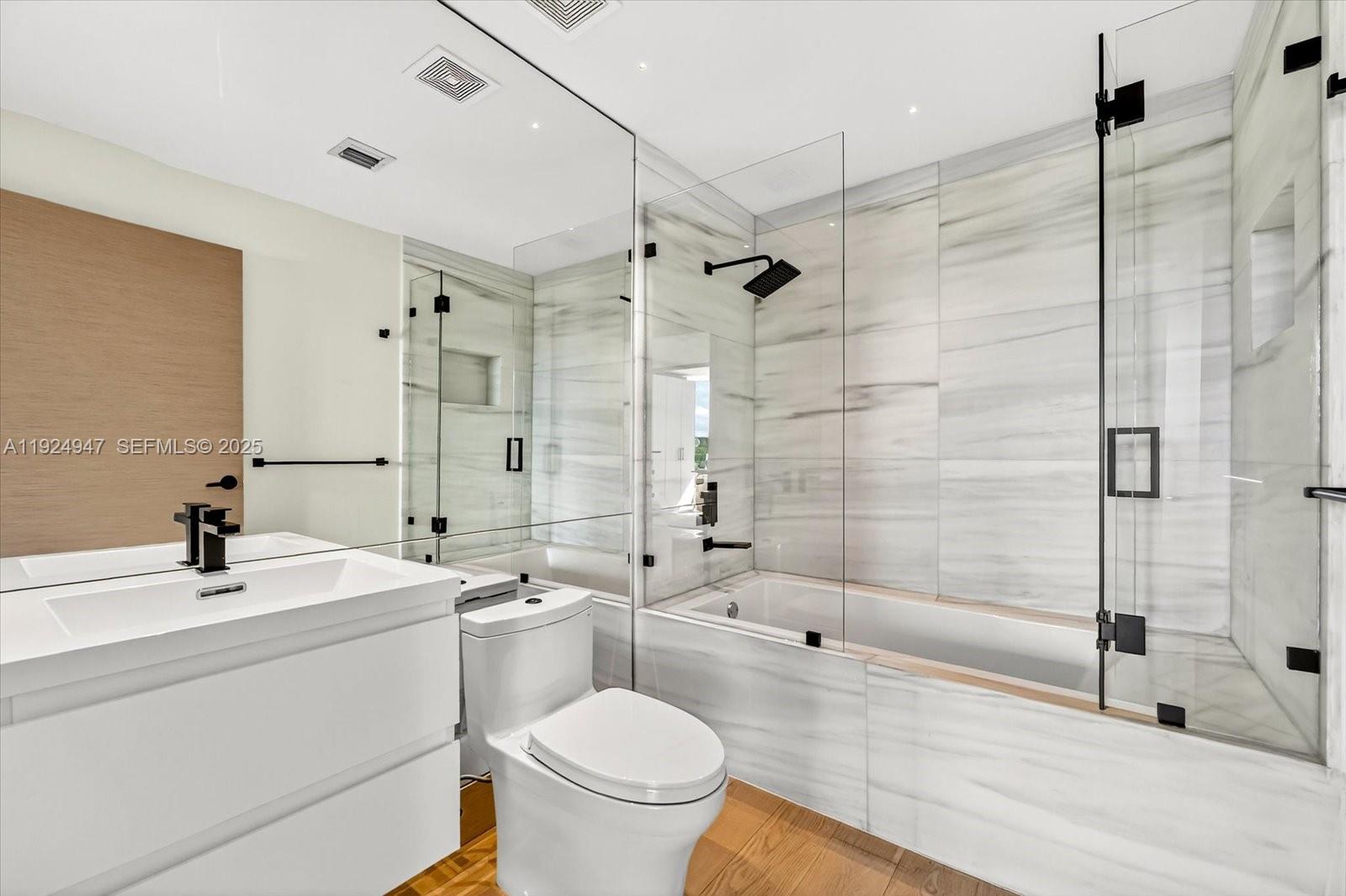 1201 20th Street, Unit PH07 Miami Beach, FL 33139 - Photo 14 of 30 a bathroom with a sink toilet and shower