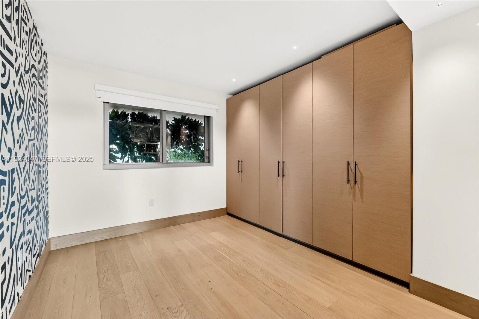 1201 20th Street, Unit PH07 Miami Beach, FL 33139 - Photo 15 of 30 an empty room with wooden floor and windows