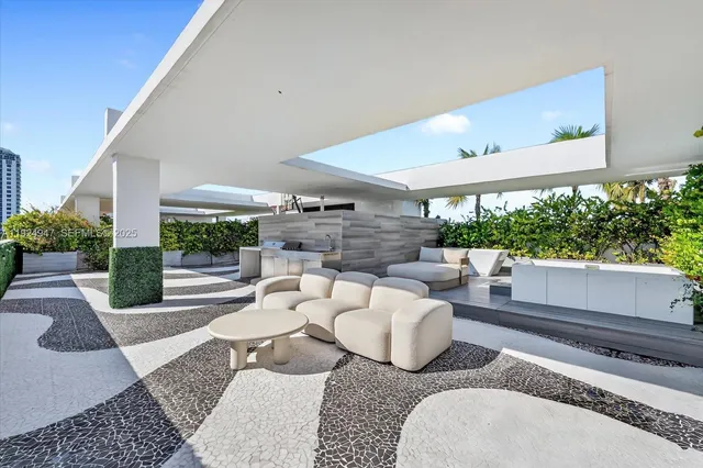 a view of a patio with couches and potted plants