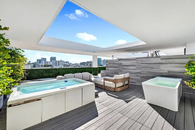 a view of a terrace with couches and potted plants
