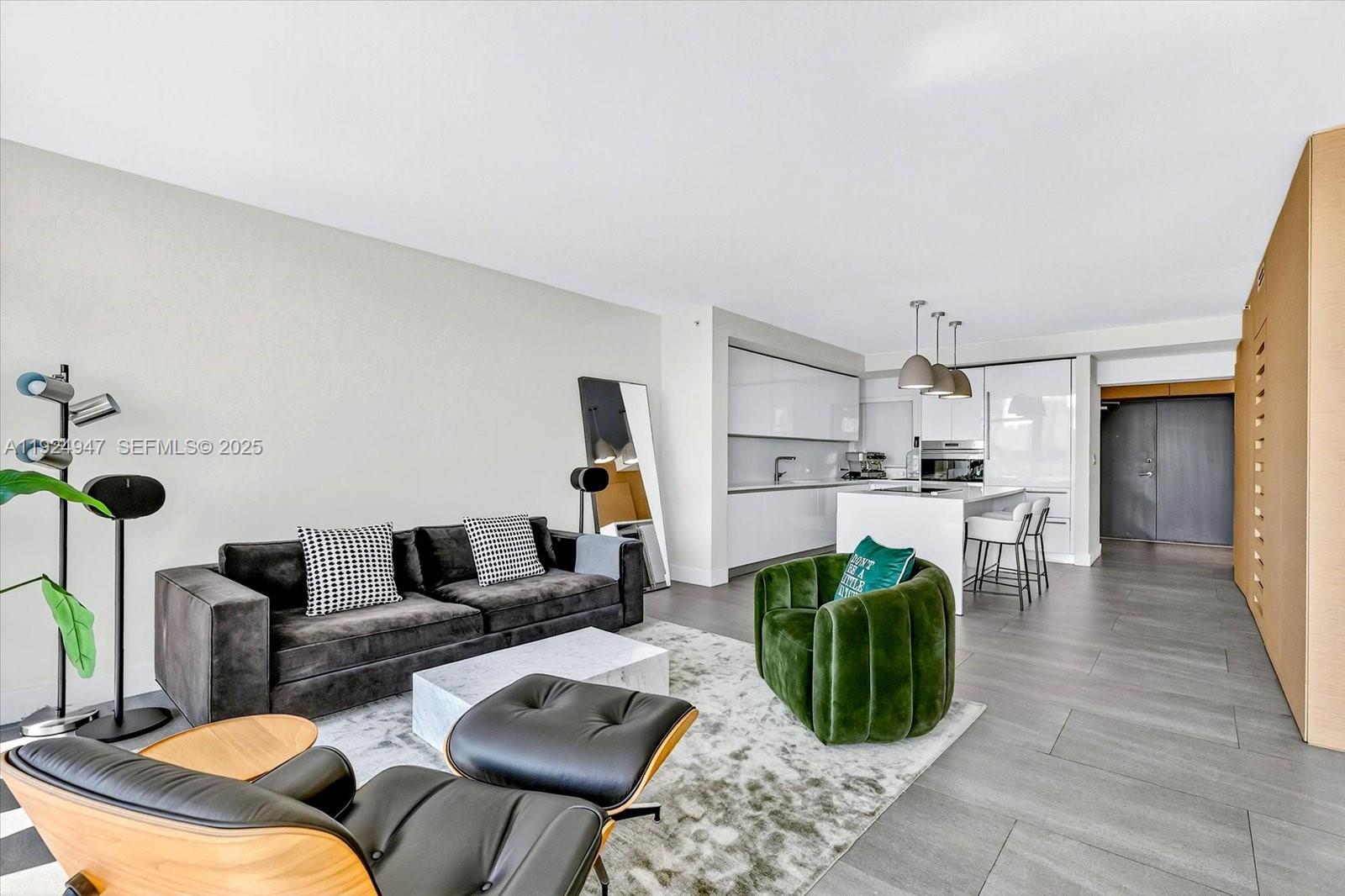 1201 20th Street, Unit PH07 Miami Beach, FL 33139 - Photo 5 of 30 a living room with furniture a rug and kitchen view