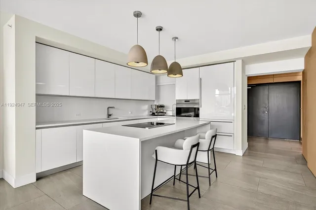 a kitchen with stainless steel appliances a stove a refrigerator and cabinets