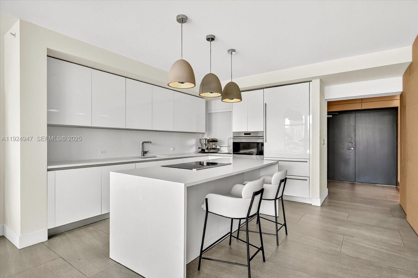 1201 20th Street, Unit PH07 Miami Beach, FL 33139 - Photo 8 of 30 a kitchen with stainless steel appliances a stove a refrigerator and cabinets