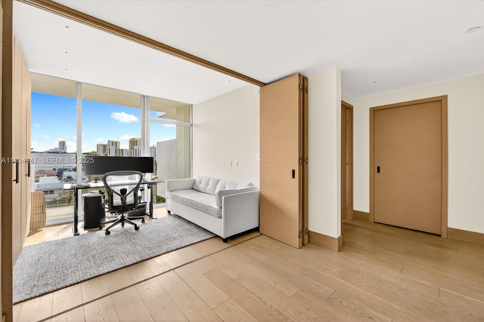 1201 20th Street, Unit PH07 Miami Beach, FL 33139 - Photo 10 of 30 a living room with couches and kitchen view with wooden floor
