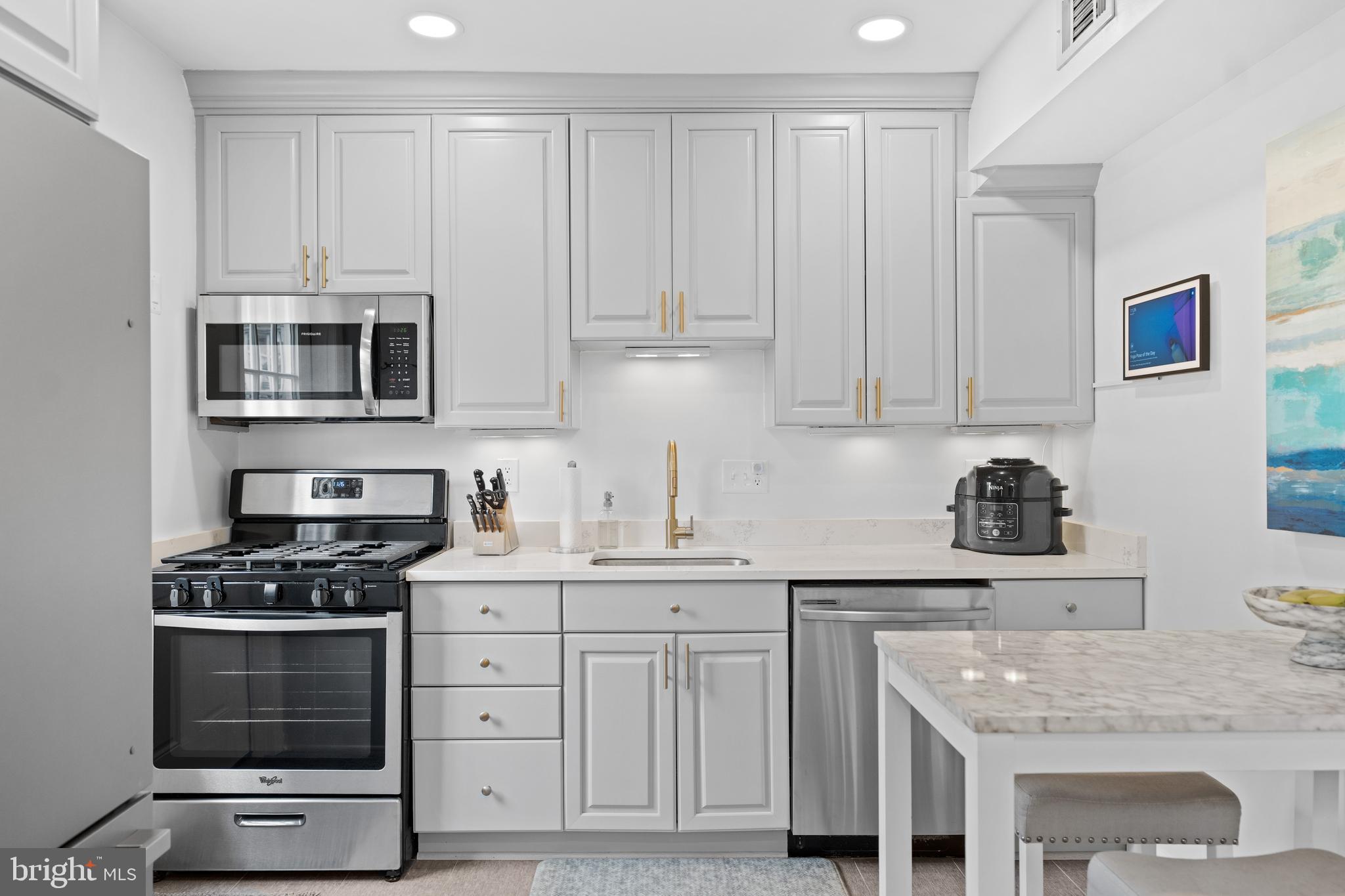 2837 Cameron Road Falls Church, VA 22042 - Photo 13 of 42 a kitchen with granite countertop a stove sink and cabinets