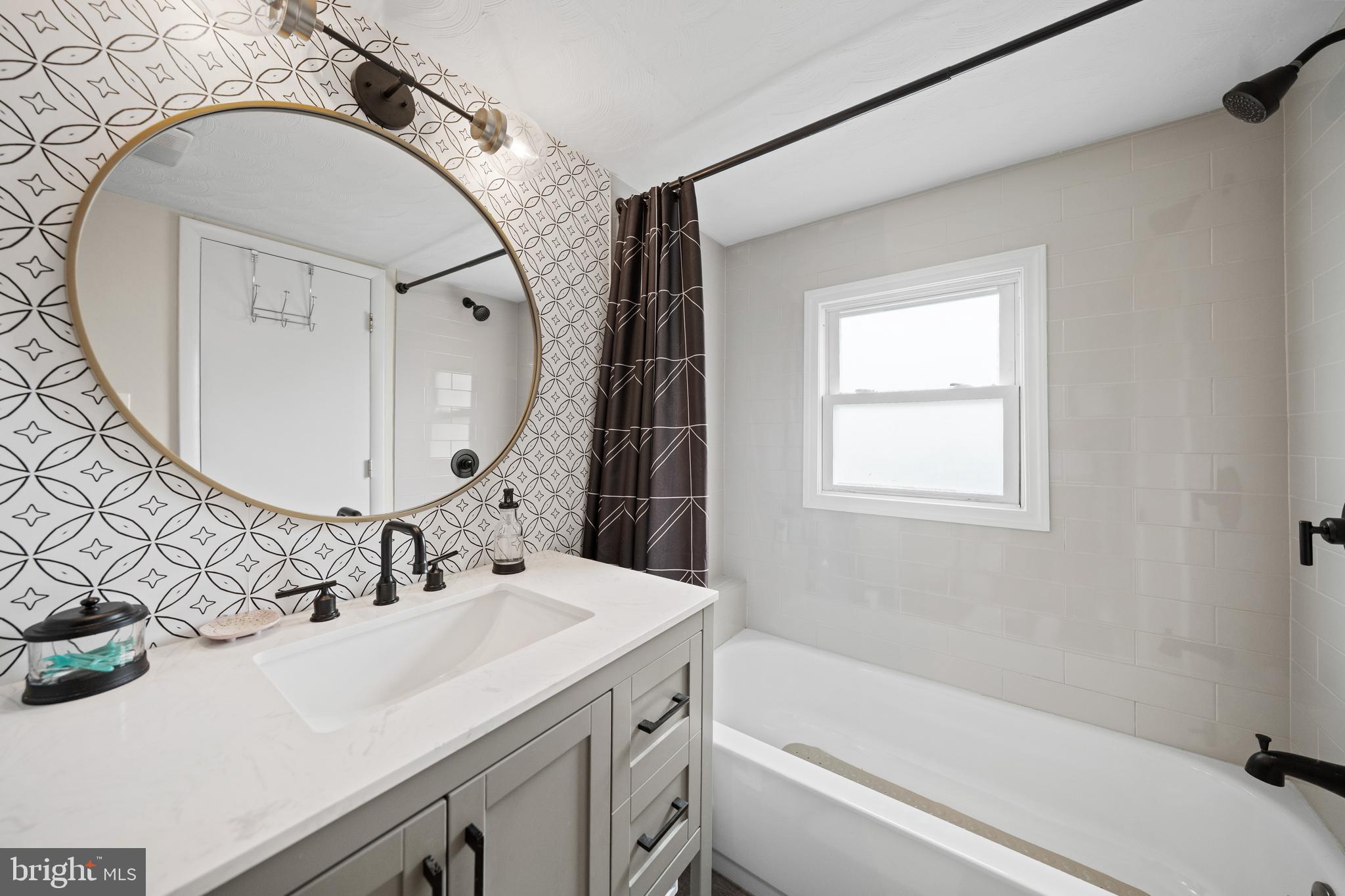 2837 Cameron Road Falls Church, VA 22042 - Photo 27 of 42 a bathroom with a sink a mirror a bathtub and shower